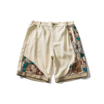 Load image into Gallery viewer, PANELED EMBROIDERED KNEE SHORTS
