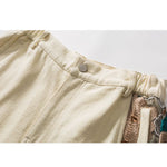 Load image into Gallery viewer, PANELED EMBROIDERED KNEE SHORTS
